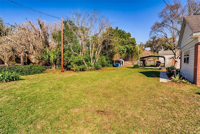 view of yard featuring an outbuilding and a detached carport