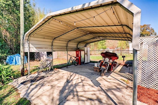 view of car parking with a carport and fence