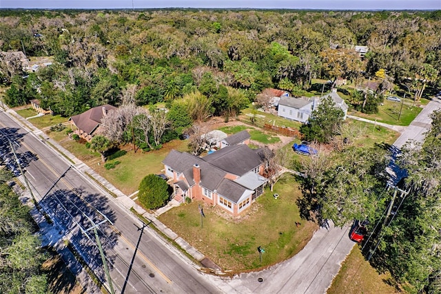 drone / aerial view featuring a view of trees