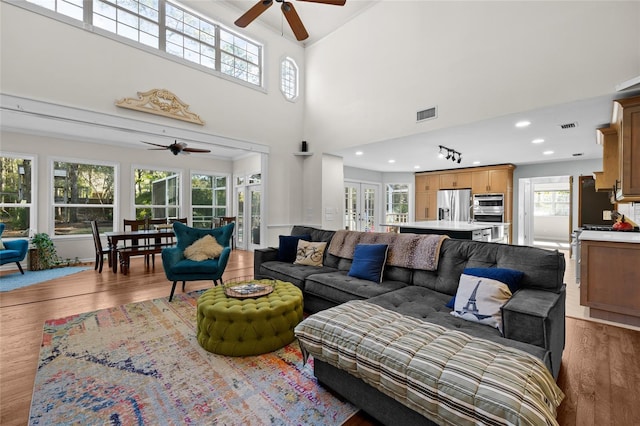 living room featuring recessed lighting, visible vents, wood finished floors, and a ceiling fan