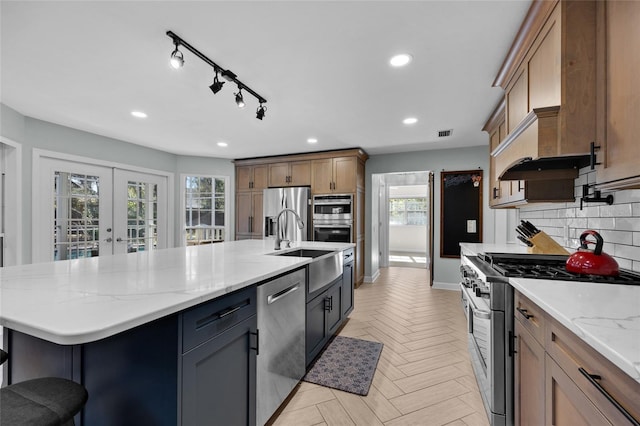 kitchen with a spacious island, backsplash, recessed lighting, appliances with stainless steel finishes, and french doors