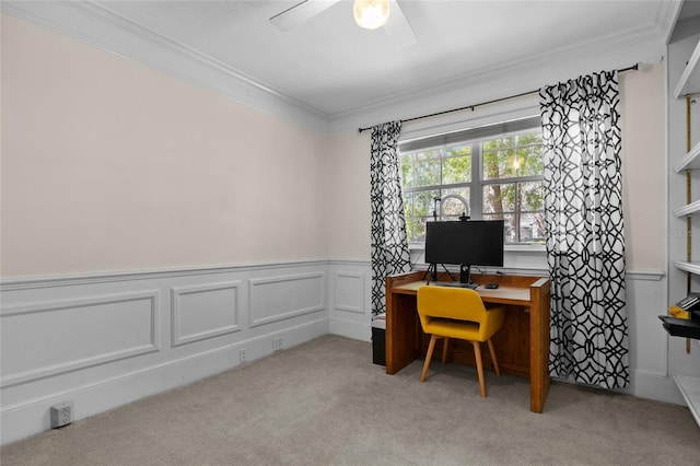 office area featuring wainscoting, light colored carpet, ceiling fan, and ornamental molding