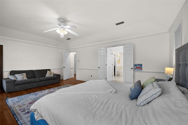 bedroom featuring wood finished floors, visible vents, and ceiling fan