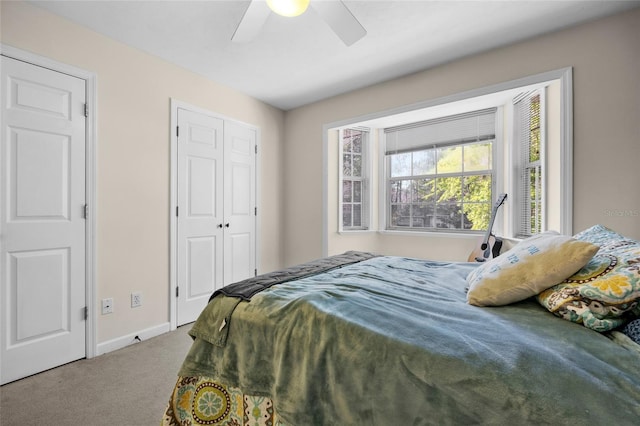 bedroom featuring baseboards, carpet floors, a closet, and a ceiling fan