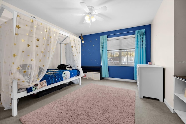 carpeted bedroom with baseboards and a ceiling fan