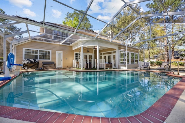 outdoor pool with a ceiling fan, french doors, a grill, a lanai, and a patio area