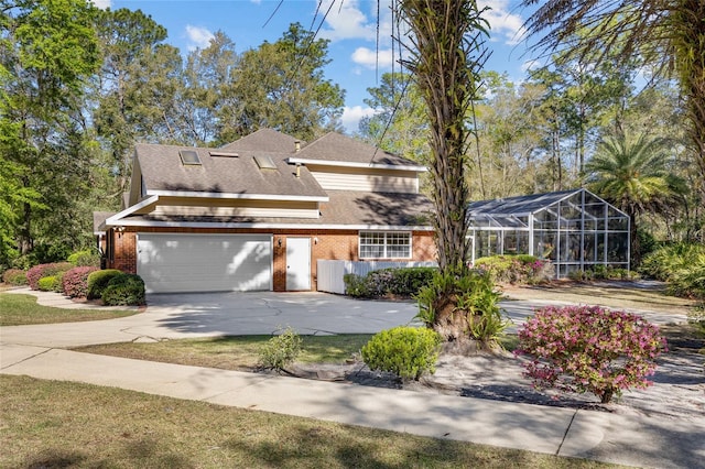 view of front of house with a lanai, brick siding, concrete driveway, and a shingled roof