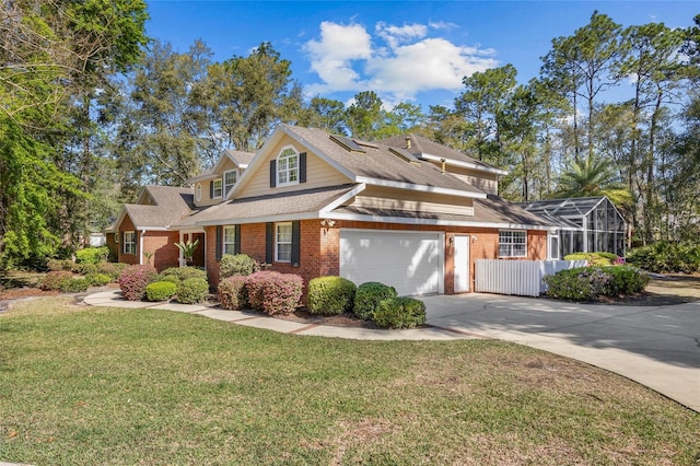 view of front of property featuring brick siding, concrete driveway, a front yard, and a shingled roof