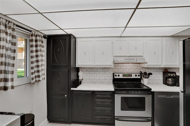 kitchen with tasteful backsplash, a paneled ceiling, white cabinets, stainless steel range with electric cooktop, and under cabinet range hood