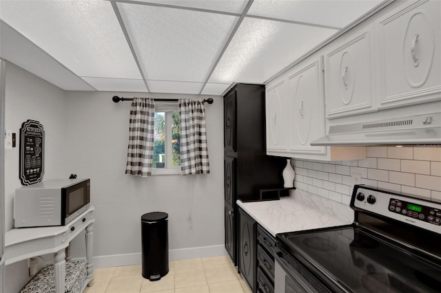 kitchen featuring decorative backsplash, stainless steel electric range, light countertops, under cabinet range hood, and white cabinetry