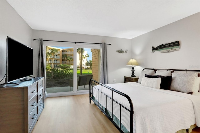 bedroom with light wood-type flooring and access to outside