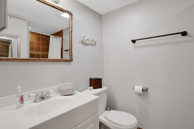 bathroom with toilet, curtained shower, a textured ceiling, and vanity