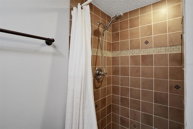 full bathroom featuring a shower stall and a textured ceiling