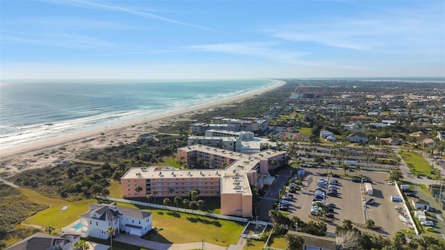 drone / aerial view featuring a water view and a view of the beach