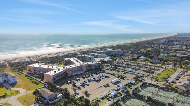 birds eye view of property featuring a water view and a beach view