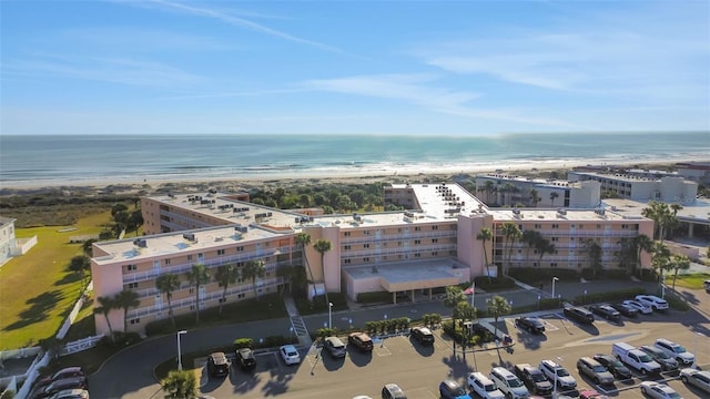 bird's eye view with a water view and a beach view