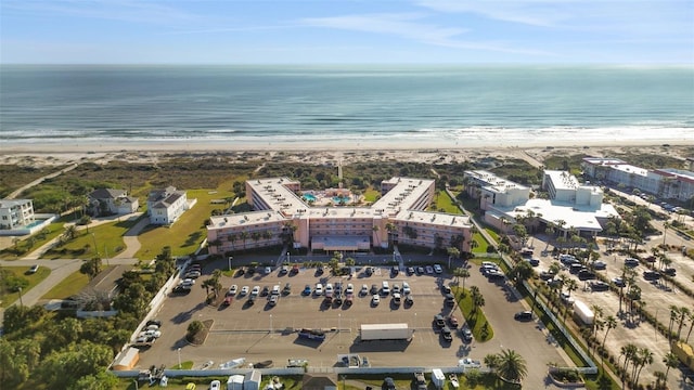 bird's eye view featuring a water view and a beach view