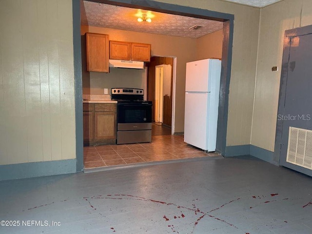 kitchen with stainless steel electric range oven, white refrigerator, and a textured ceiling