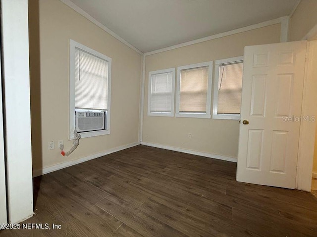 spare room featuring cooling unit, dark wood-type flooring, and crown molding