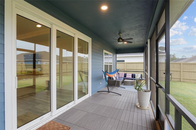 sunroom featuring ceiling fan