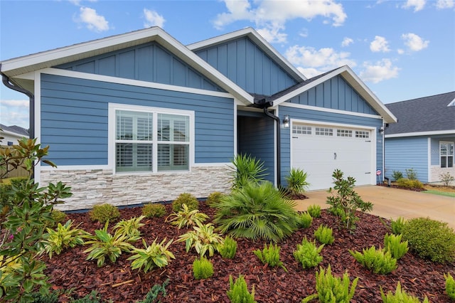 craftsman inspired home with a garage, stone siding, board and batten siding, and concrete driveway