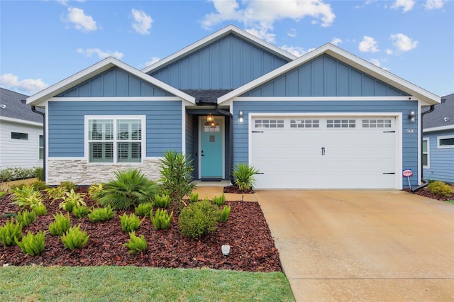 view of front facade featuring a garage, stone siding, driveway, and board and batten siding