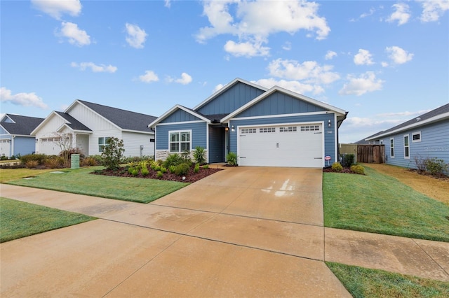 view of front of property with board and batten siding, a garage, a front lawn, and concrete driveway