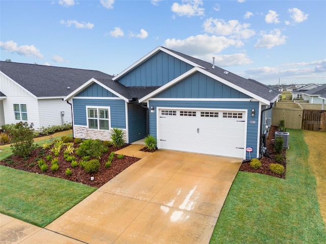 view of front of property with a garage, a shingled roof, a front lawn, and board and batten siding