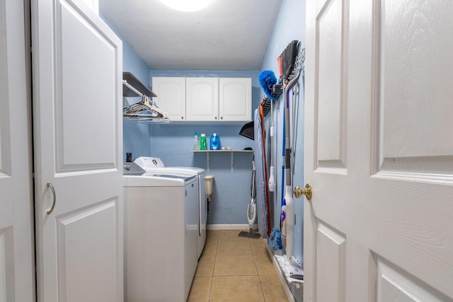 laundry room with cabinet space, light tile patterned flooring, and independent washer and dryer