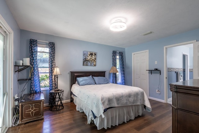 bedroom featuring visible vents, dark wood finished floors, and baseboards