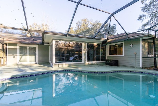 outdoor pool with a lanai and a patio