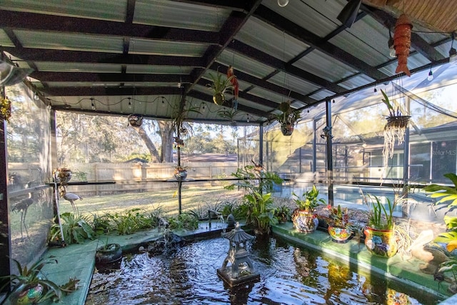 exterior space with fence, a pool, and a garden pond