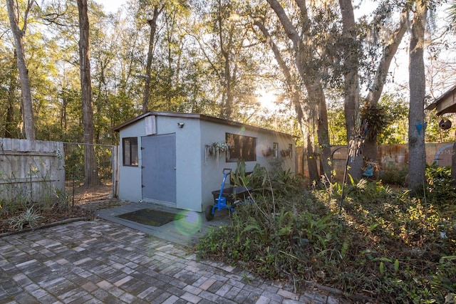 view of outbuilding featuring a fenced backyard and an outbuilding