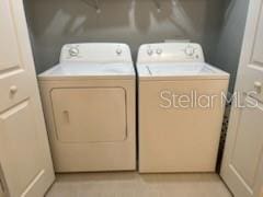 clothes washing area with laundry area and independent washer and dryer