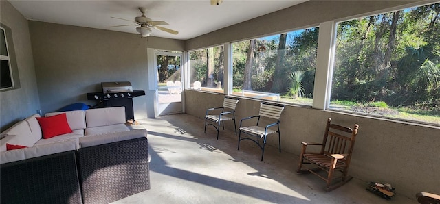 sunroom featuring a ceiling fan