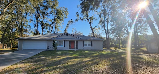 single story home featuring a garage, a front yard, and driveway