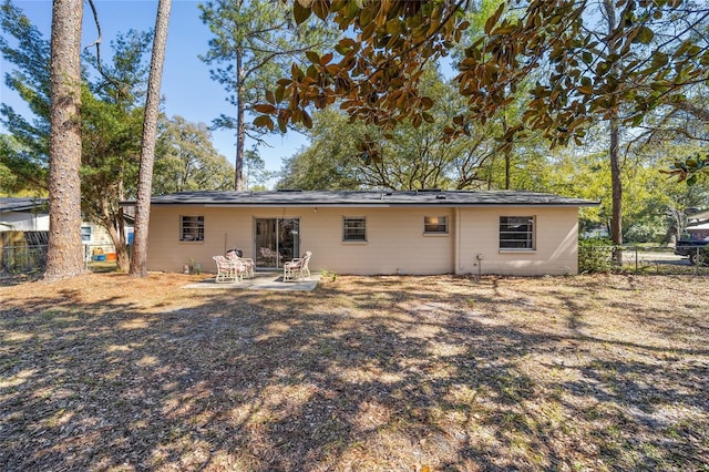 back of property featuring a patio area and fence