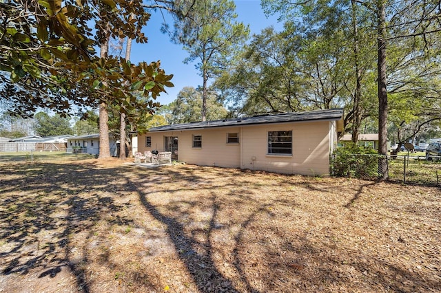 back of house with fence