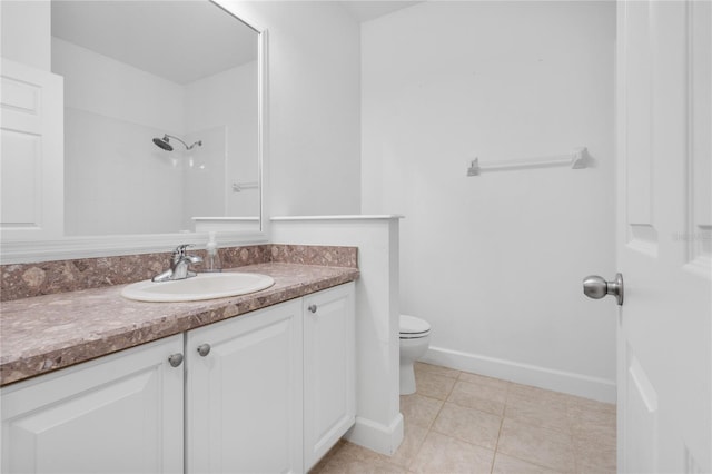 bathroom with toilet, vanity, baseboards, tile patterned floors, and walk in shower