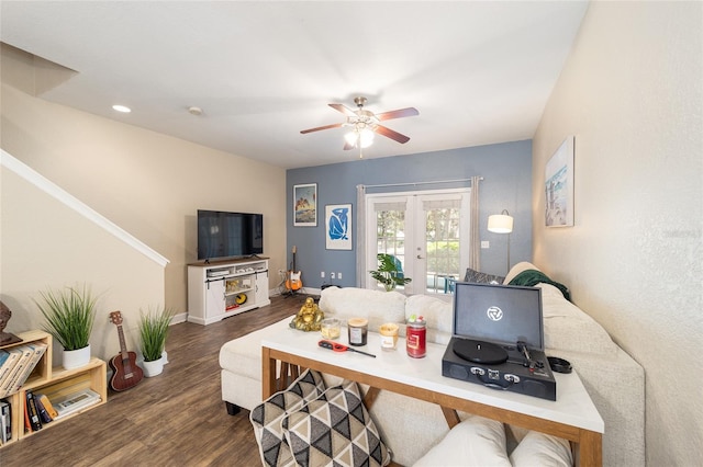 living area featuring a ceiling fan, baseboards, wood finished floors, and french doors