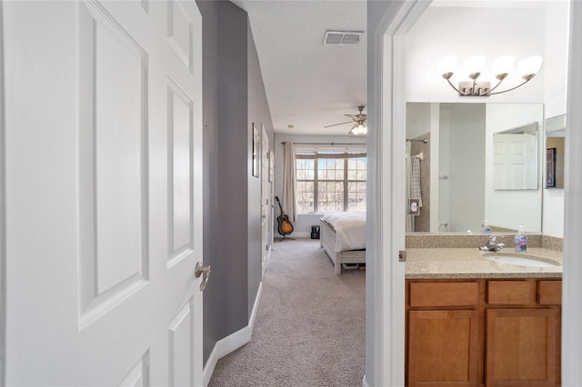 full bath with visible vents, a ceiling fan, vanity, ensuite bath, and baseboards