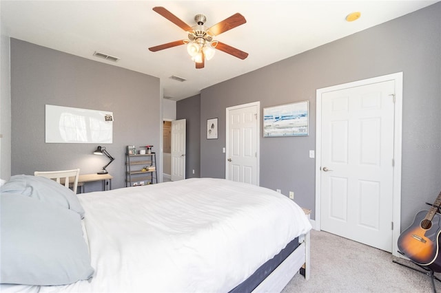 bedroom with ceiling fan, visible vents, and light colored carpet