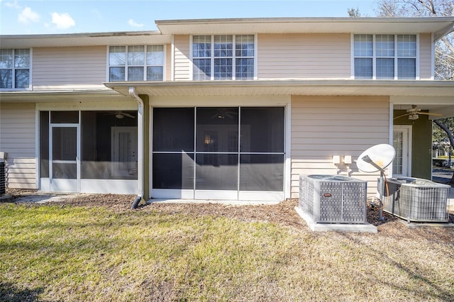 back of house with a ceiling fan, a sunroom, central AC, and a yard