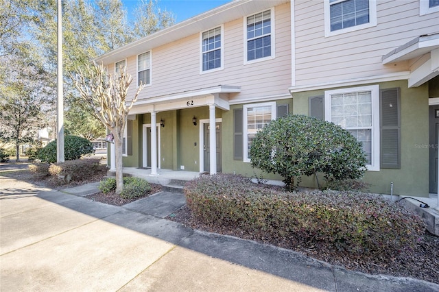 view of front of house featuring a porch and stucco siding