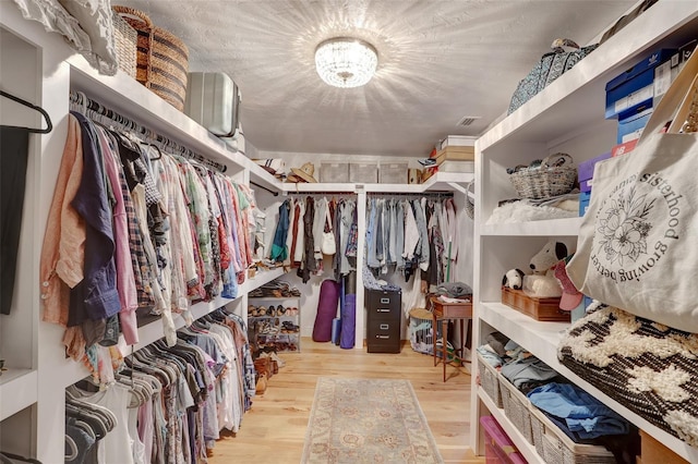 spacious closet with visible vents and wood finished floors