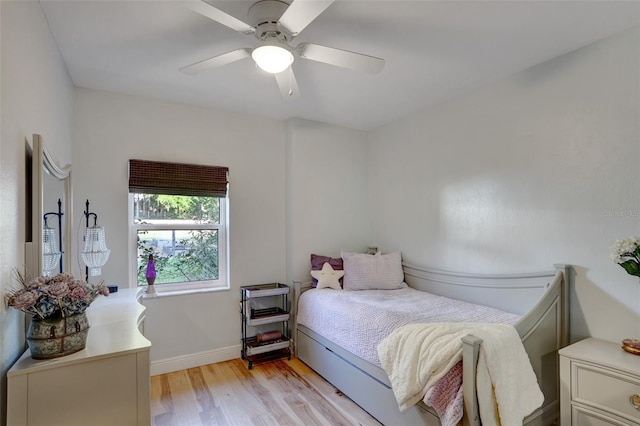 bedroom featuring light wood-type flooring, ceiling fan, and baseboards