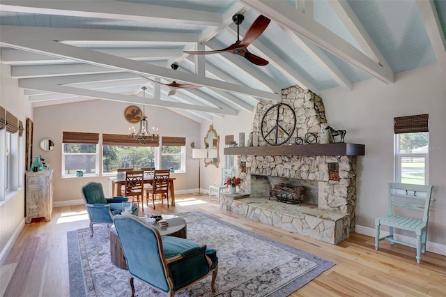 living area featuring a fireplace, lofted ceiling with beams, and wood finished floors