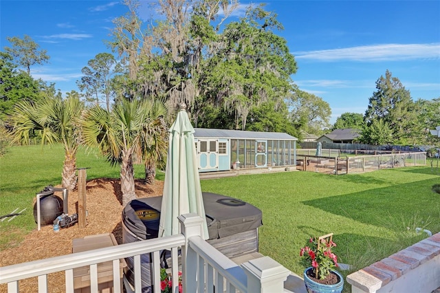 view of yard with fence, an exterior structure, and an outdoor structure