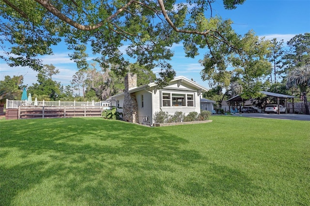 view of yard featuring a carport and fence