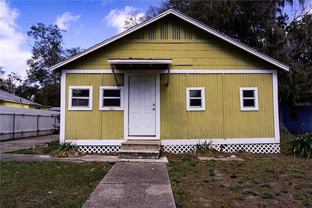 view of outdoor structure with entry steps and fence